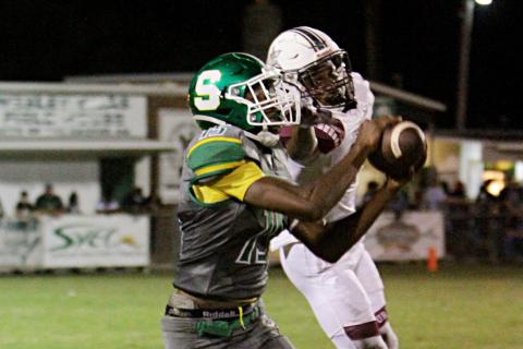 Suwannee receiver Brian Fuery catches a pass in front of a Madison County defender last Friday. (PAUL BUCHANAN/Special to the Reporter)