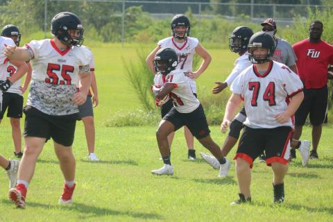 Fort White running back Tavion Taylor carries the ball up the field during Tuesday’s practice. (JORDAN KROEGER/Lake City Reporter)