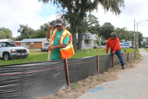 Construction workers erect erosion control black fencing around the Circle K store site at the intersection of U.S. Highway 90 and Baya Drive Wednesday morning. The store is expected to be completed within 22 weeks. (TONY BRITT/Lake City Reporter)