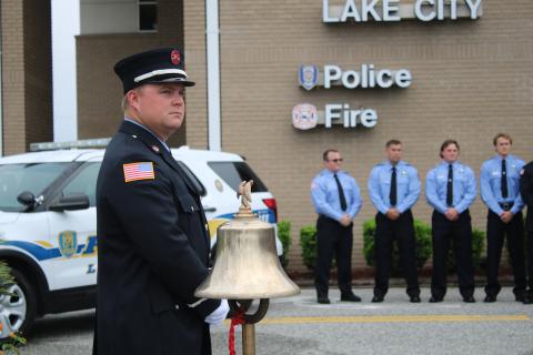Daniel Dorn, a Lake City Fire Department driver/engineer, stands near a bell that was rung in honor of 9/11 terrorist attack victims Friday morning. (TONY BRITT/Lake City Reporter)
