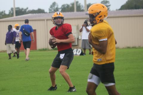 Columbia quarterback Kade Jackson drops back to pass during practice on Monday. Jackson is competing for the starting quarterback position with Ty Wehinger. (JORDAN KROEGER/Lake City Reporter)