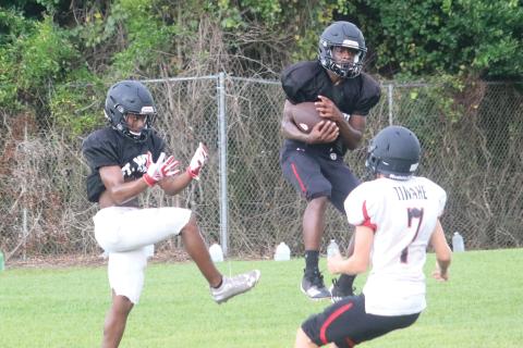 Fort White defensive back Gene Smith intercepts a pass during Wednesday’s practice. (JORDAN KROEGER/Lake City Reporter)