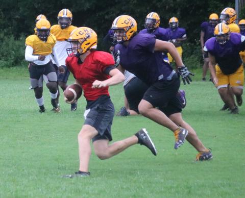 Columbia defensive end Jaiden Tillotson chases down quarterback Kade Jackson during Monday’s practice. (JORDAN KROEGER/Lake City Reporter)