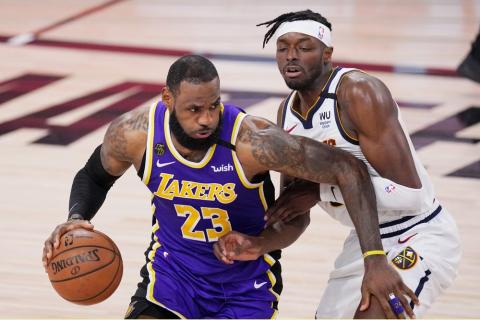 Los Angeles Lakers' LeBron James (23) drives against Denver Nuggets' Jerami Grant during Game 5 of the Western Conference finals on Saturday, in Lake Buena Vista. (MARK J. TERRILL/Associated Press)