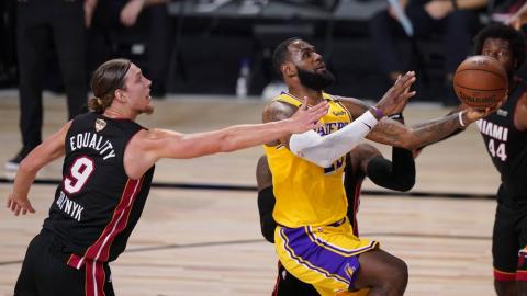 Los Angeles Lakers' LeBron James, right, drives to the basket past Miami Heat's Kelly Olynyk (9) during the second half of Game 1 of basketball's NBA Finals on Wednesday, in Lake Buena Vista. (MARK J. TERRILL/Associated Press)