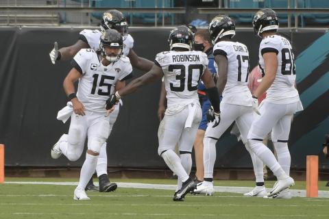 Jacksonville Jaguars quarterback Gardner Minshew (15) celebrates after throwing a touchdown pass to wide receiver D.J. Chark (17) during the first half of an NFL football game against the Indianapolis Colts on Sunday, in Jacksonville. (AP PHOTO)