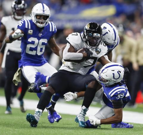 Jacksonville Jaguars running back Leonard Fournette (27) is surrounded by Indianapolis Colts defenders on this second half run at Lucas Oil Stadium on Nov. 17, 2019,  in Indianapolis, Ind. Fournette was released by the Jaguars on Monday and went unclaimed on waivers Tuesday. (SAM RICHE/TNS)