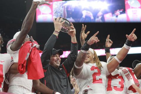Ohio State coach Ryan Day holds up the trophy after their 34-21 come from behind win over Wisconsin at the Big Ten Championship Game at Lucas Oil Field on Dec. 7 2019, in Indianapolis. (DAVID PETKIEWICZ/cleveland.com/TNS)