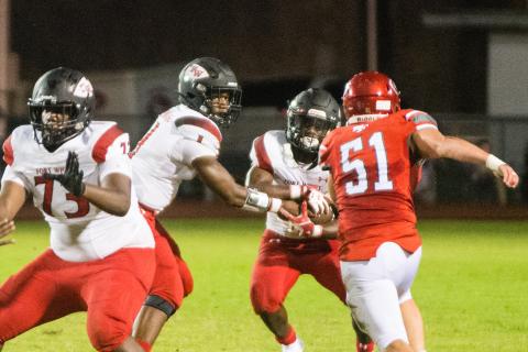 Fort White quarterback Tyler Jefferson hands the ball off to running back Tavion Taylor on Friday night. (CHRISTINA FEAGIN/Special to the Reporter)