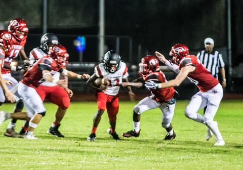 Fort White receiver Najeeb Smith is surrounded by Santa Fe defenders last week. (CHRISTINA FEAGIN/Special to the Reporter)