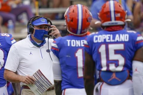 Florida head coach Dan Mullen, left, talks with wide receivers Kadarius Toney (1) and Jacob Copeland (15) during a timeout in a game against South Carolina on Oct. 3 in Gainesville. (JOHN RAOUX/AP Pool Photo)