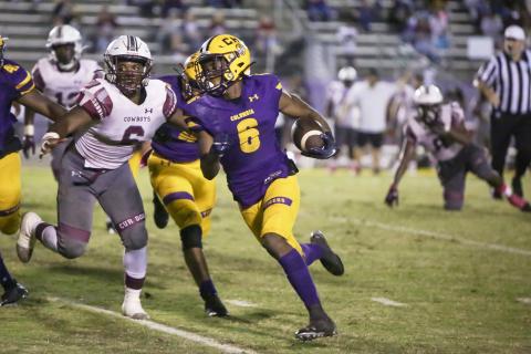 Columbia receiver Tray Tolliver runs it up the field out of the read option against Madison County on Friday night. (BRENT KUYKENDALL/Lake City Reporter)