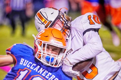 Branford’s Adrik Miller delivers a hit against Trenton’s Caleb Morgan on Friday night. (BRIAN LEWIS/Special to the Reporter)
