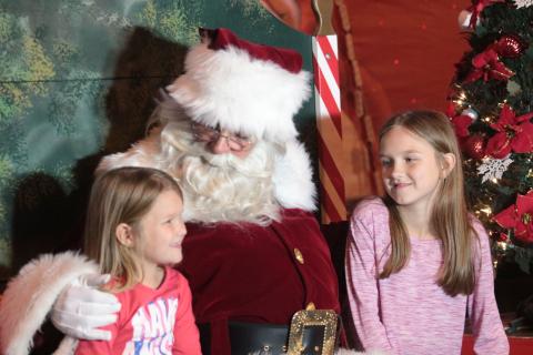 Santa Claus visits with Evelyn, left, and Darcy Floyd at last year’s Christmas on the Square in Live Oak. The Suwannee County Chamber of Commerce announced Tuesday the 36th annual festival will be held this year with safety protocols in place for the covid-19 pandemic. (SUWANNEE DEMOCRAT)