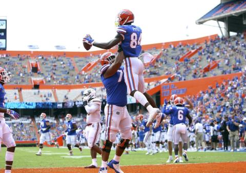 Florida tight end Kyle Pits (84) leaps up as he celebrates a touchdown catch with teammates against South Carolina on Saturday, in Gainesville. (BEAD MCCLENNY/The Gainesville Sun via AP, Pool)