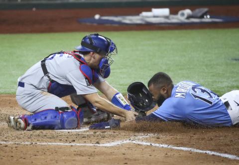 Los Angeles Dodgers catcher Austin Barnes (15) places the tag on Tampa Bay Rays left fielder Manuel Margot as Margot attempted to steal home plate during the fourth inning in Game 5 of the World Series between the Tampa Bay Rays and the Los Angeles Dodgers on Sunday in Arlington, TX. (TRIBUNE NEWS SERVICE)