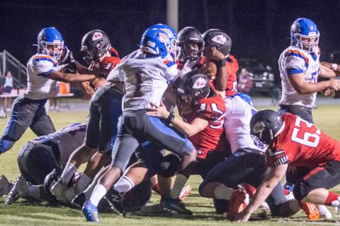 Fort White quarterback Tyler Jefferson looks for running room as his offensive line tries to block Taylor County on Oct. 2. (CHRISTINA FEAGIN/Special to the Reporter)