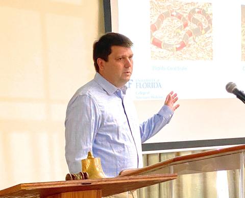 Dr. Travis Lanaux, DVM, emergency director of the University of Florida’s small animal hospital, talks about the treatment of snake bites in dogs during a presentation to the Rotary Club of Lake City Thursday. Lanaux talked about coral snake bites and strikes from pit vipers, including rattlesnakes, cottonmouths and copperheads. (TODD WILSON/Lake City Reporter)