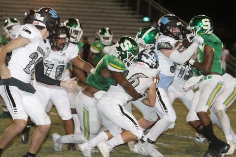 Suwannee defensive lineman Garris Reed, left, and linebacker Blaine Howard wrap up Ponte Vedra running back Campbell Parker on Friday night. (PAUL BUCHANAN/Special to the Reporter)