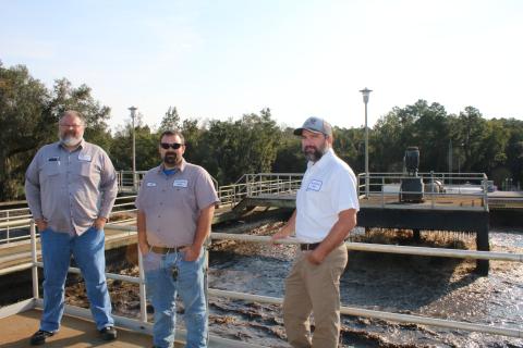 Bill Fish (from left), Tyler Todd and Cody Pridgeon stand atop a monitoring area for the aeration basin tanks at the St. Margarets Wastewater Treatment Facility on Friday morning. The aeration basin tanks  will be upgraded as part of a $6.1 million project at the facility. (TONY BRITT/Lake City Reporter)