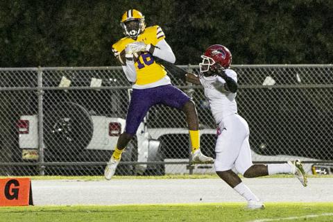 Columbia receiver Marcus Peterson catches a touchdown pass against North Miami Beach in the first quarter Friday night. Peterson also threw three touchdown passes in the fourth quarter to lead the Tigers to a come-from-behind victory. (JEN CHASTEEN/Special to the Reporter)