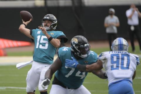 Jacksonville Jaguars quarterback Gardner Minshew II (15) throws a pass as offensive tackle Cam Robinson (74) blocks Detroit Lions defensive end Trey Flowers (90) on Oct. 18 in Jacksonville. (PHELAN M. EBENHACK/Associated Press)