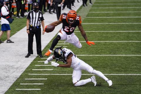 Cincinnati Bengals running back Joe Mixon (28) leaps over Jacksonville Jaguars cornerback Chris Claybrooks (27) for a touchdown on Sunday, in Cincinnati. (BRYAN WOOLSTON/Associated Press)