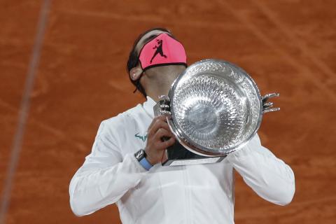Rafael Nadal holds the trophy as he celebrates winning the final match of the French Open against Novak Djokovic in three sets, 6-0, 6-2, 7-5, at the Roland Garros stadium on Sunday in Paris, France. (ALESSANDRA TARATINO/Associated Press)