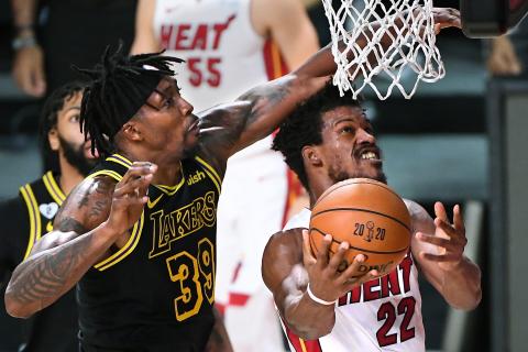Los Angeles Lakers center Dwight Howard fouls Miami Heat forward Jimmy Butler (22) as he drives to the basket in the first quarter during Game 5 of the NBA Finals on Friday at AdventHealth Arena at ESPN Wide World Of Sports Complex in Lake Buena Vista. The Heat won, 111-108, to force a Game 6. (WALLY SKALIJ/Los Angeles Times/TNS