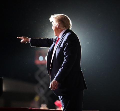 President Donald Trump waves goodbye to cheering supporters as he departs his campaign rally at Orlando Sanford International Airport in Sanford, Fla., on Monday. (JOE BURBANK/Orlando Sentinel/TNS) 