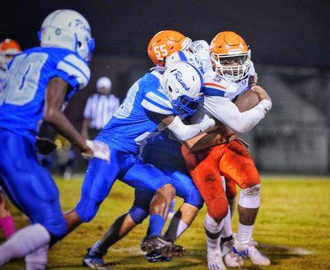 Branford running back Markell Pugh powers through an Interlachen defender Friday night. (BRIAN LEWIS/Special to the Reporter)
