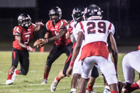 Fort White quarterback Tyler Jefferson hands the ball off to running back Tavion Taylor against Baldwin last Friday. (CHRISTINA FEAGIN/Special to the Reporter)