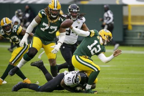 Jacksonville Jaguars' Josh Allen takes down Green Bay Packers' Aaron Rodgers on Sunday in Green Bay, Wis. Roughing the passer was called on the play. (MIKE ROEMER/Associated Press)