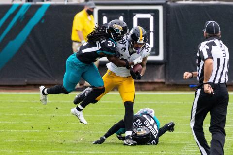 Jacksonville Jaguars cornerback Tre Herndon (37) makes the tackle on Pittsburgh Steelers running back James Conner (30) at TIAA Bank Field last Sunday in Jacksonville. (MATT PENDLETON/TNS)