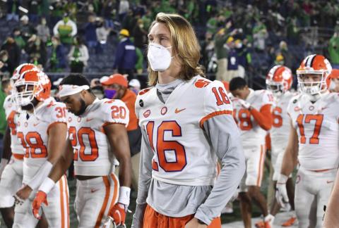 Clemson quarterback Trevor Lawrence (16) leaves the field with his teammates after Clemson lost to Notre Dame 47-40 in two overtimes on Nov. 7 in South Bend, Ind. As virus disruptions mount and the Dec. 19 end of college football's regular season draws closer, the possibility grows that conference championships, major awards and even College Football Playoff participants will be determined by covid-19. (MATT CASHORE/AP Pool File Photo)