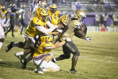 Columbia’s A’deon Farmer (7), Nate Walmsley (92) and Lane Mote (42) gang tackle Daytona Beach Mainland running back Gregory Mango during Friday’s Region 1-6A semifinal. (BRENT KUYKENDALL/Lake City Reporter)