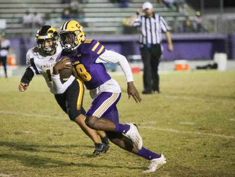 Columbia quarterback Marcus Peterson speeds past an Englewood defender during Friday’s Region 1-6A play-in playoff game. (BRENT KUYKENDALL/Lake City Reporter)