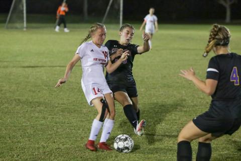 Columbia’s Isa Maranto fights for possession of the ball with Keystone Heights’ Lindsay Hovsepian on Monday night. (BRENT KUYKENDALL/Lake City Reporter)