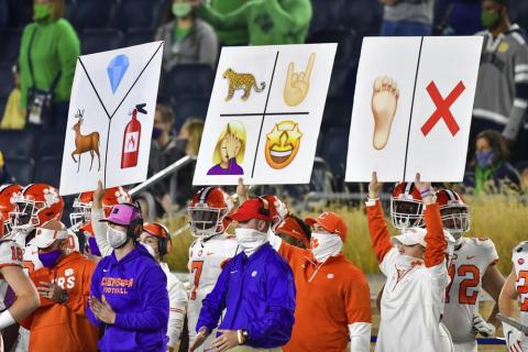 Clemson sideline personnel hold play signal cards during the third quarter of the team's game against Notre Dame on Nov. 7 in South Bend, Ind. (MATT CASHORE/AP Pool Photo)