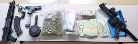 Four firearms, $10,000 in cash and 1.5 pounds of marijuana were found during a drug bust Thursday night sparked by a single-vehicle wreck. (COURTESY)