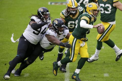 Green Bay Packers' Aaron Rodgers scrambles against the Jacksonville Jaguars Sunday in Green Bay, Wis. (MIKE ROEMER/Associated Press)