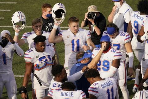 Florida quarterback Kyle Trask (11) joins head coach Dan Mullen, center, in singing their school song after a game against Vanderbilt on Nov. 21 in Nashville, Tenn. Florida won 38-17. (MARK HUMPHREY/Associated Press)