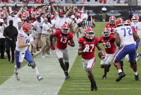 Georgia defensive back Eric Stokes (27) returns an interception for a touchdown against Florida on Saturday in Jacksonville. (CURTIS COMPTON Compton/Atlanta Journal-Constitution via AP)
