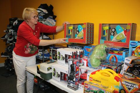 Meally Jenkins, Christmas Dream Machine founder and director, arranges toys in the agency’s office Friday afternoon. The Christmas Dream Machine opened Sunday and has already compiled a list of 100 children to serve this holiday season. (TONY BRITT/Lake City Reporter)
