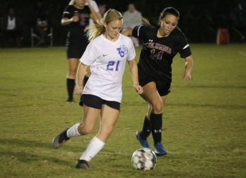Columbia midfielder Taiya Driggers chases down possession from Taylor County’s  Rebecca Shoaff on Monday night. (JORDAN KROEGER/Lake City Reporter)