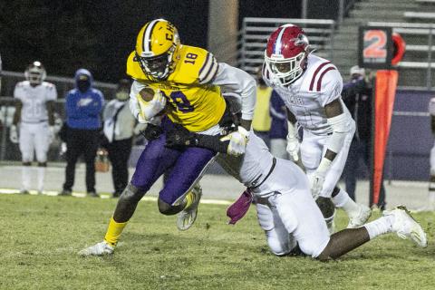 Columbia receiver Marcus Peterson tries to escape a tackle against North Miami Beach last Friday. (JEN CHASTEEN/Special to the Reporter)