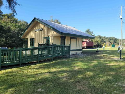 Historic Mayor’s Park in Fort White includes an old train depot and red caboose. Exhibit signs were recently installed at the park to help detail the history of the town. (COURTESY)
