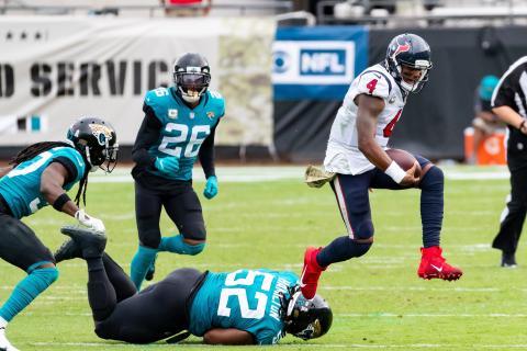 Houston Texans quarterback Deshaun Watson (4) leaps over Jacksonville Jaguars defensive tackle DaVon Hamilton (52) in the fourth quarter of Sunday's game in Jacksonville. (TRIBUNE NEWS SERVICE)