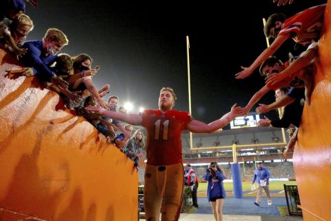 Florida quarterback Kyle Trask (11) is congratulated by fans as he leaves the field after the team's win over Arkansas on Saturday in Gainesville. (BRAD MCCLENNY/via AP)