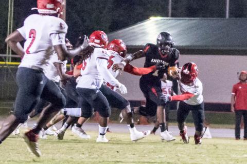 Fort White quarterback Tyler Jefferson scrambles up the field and tries to evades tackles against Hamilton County on Friday night. (CHRISTINA FEAGIN/Special to the Reporter)